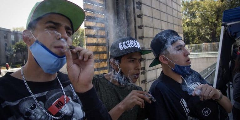 Mexican Men smoke marijuana in Mexico City in a legal zone next to Chapultepec Park.