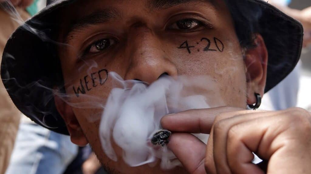 Young Mexican man smokes Marijuana in Mexico City